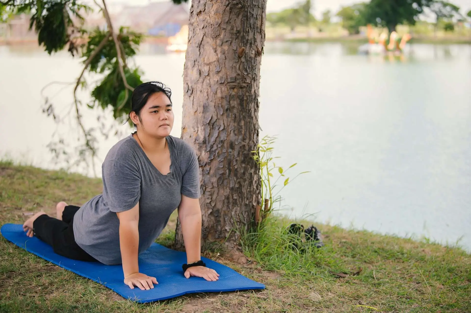 Liu doing yoga at the park,